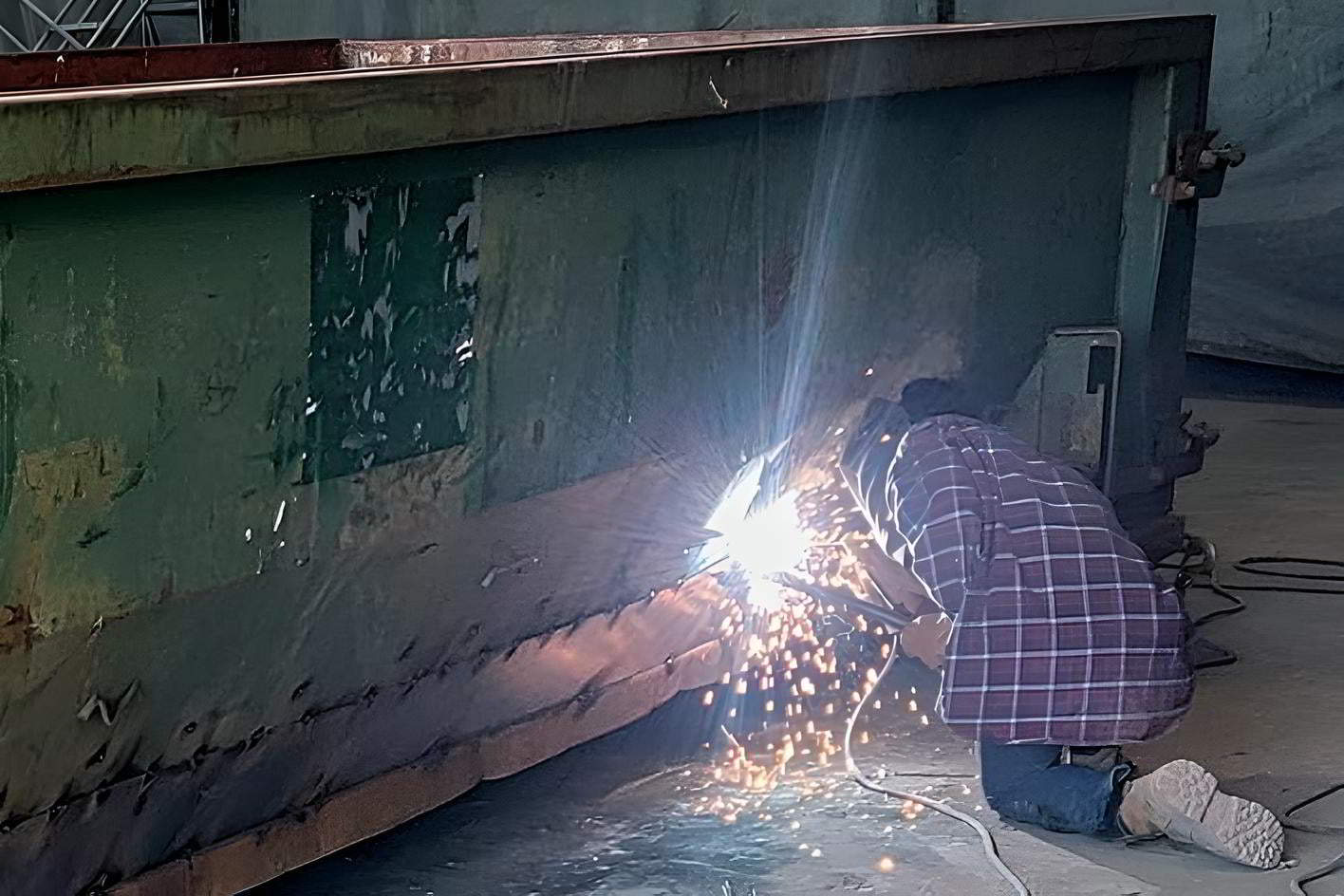 man repairing container